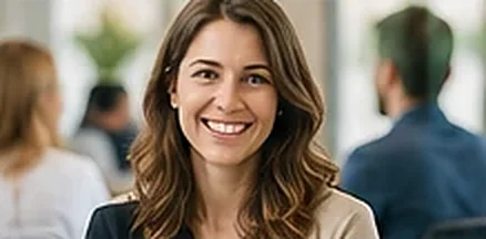 Smiling professional with colleagues behind her